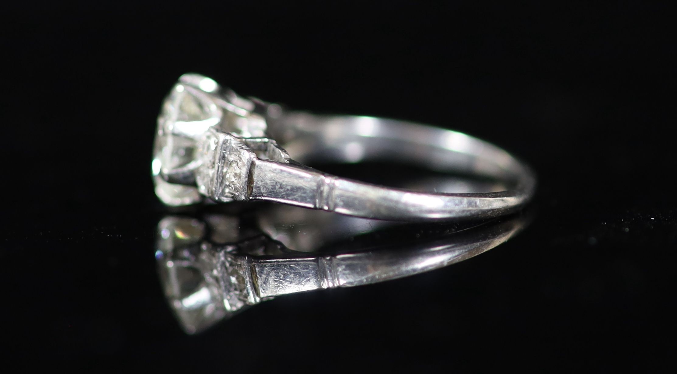 A platinum and single stone diamond ring, with six stone rose cut diamond set shoulders
